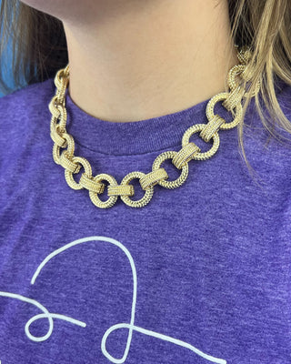 Shop the Gold Link Necklace featuring oversized textured gold links and a stylish toggle clasp for a timeless statement accessory.