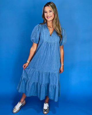 Woman wearing a blue dress against a blue background