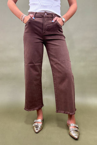 Women’s high-rise wide leg pants in chocolate brown with raw hem