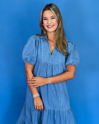 Woman wearing a blue dress against a blue background