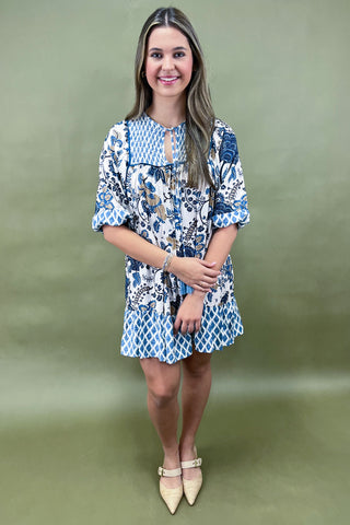 Woman wearing a floral dress against a green background
