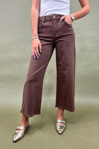 Women’s high-rise wide leg pants in chocolate brown with raw hem