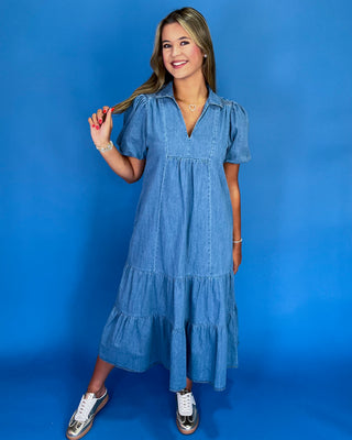 Woman wearing a blue dress against a blue background