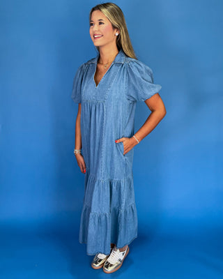 Woman wearing a blue dress against a blue background