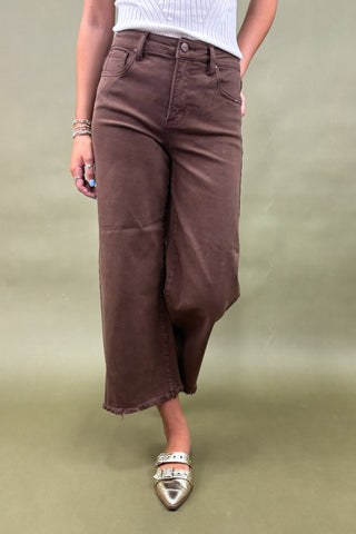 Women’s high-rise wide leg pants in chocolate brown with raw hem