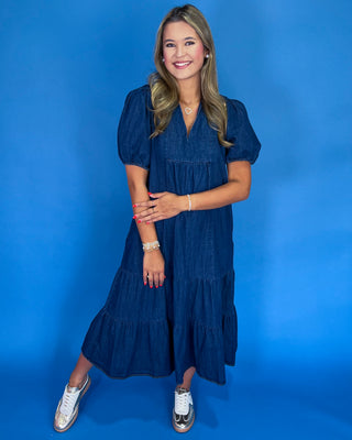 Woman wearing a blue dress against a blue background