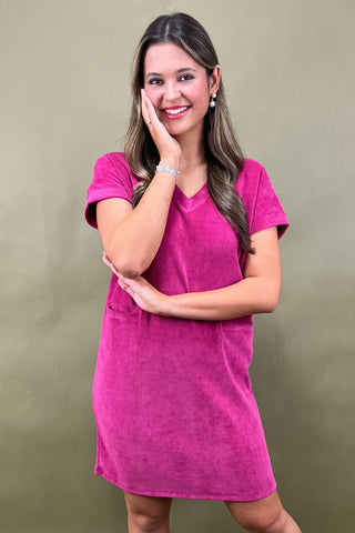 Woman wearing a pink dress against a green background