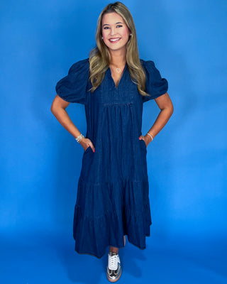 Woman wearing a blue dress against a blue background
