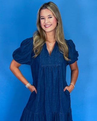 Woman wearing a blue dress against a blue background