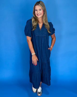 Woman wearing a blue dress against a blue background
