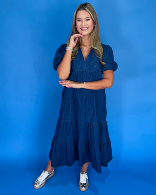 Woman wearing a blue dress against a blue background