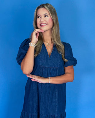 Woman wearing a blue dress against a blue background