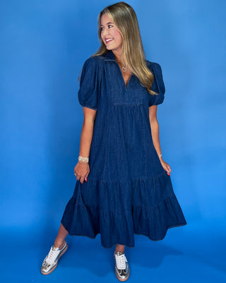 Woman wearing a blue dress against a blue background