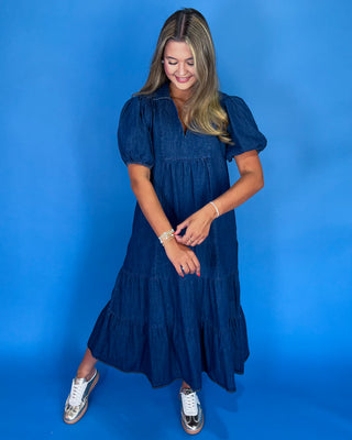 Woman wearing a blue dress against a blue background