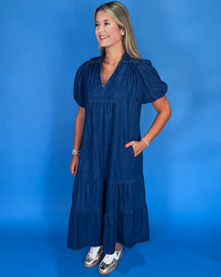 Woman wearing a blue dress against a blue background