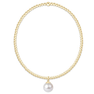 Gold necklace with a single pearl pendant on a white background