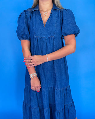Woman wearing a blue dress against a blue background