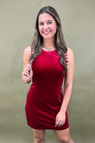 Woman wearing a red dress against a beige background