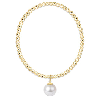 Gold beaded necklace with a white pearl pendant on a white background