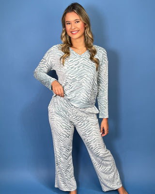 Light blue zebra print lounge set with a V-neck long sleeve top and matching relaxed-fit pants.