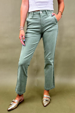 Women’s sage green straight-leg pants with side pockets, styled with a white ribbed top and metallic pointed-toe flats – casual chic outfit.