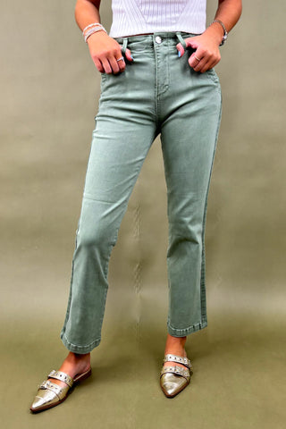 Women’s sage green straight-leg pants with side pockets, styled with a white ribbed top and metallic pointed-toe flats – casual chic outfit.