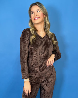Brown velvet animal print lounge set with a V-neck long sleeve top and matching relaxed-fit pants.