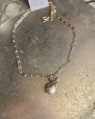 Shop the Gold Charm Necklace featuring a paperclip chain, textured gold charm, adjustable fit, and timeless style perfect for layering or everyday wear.