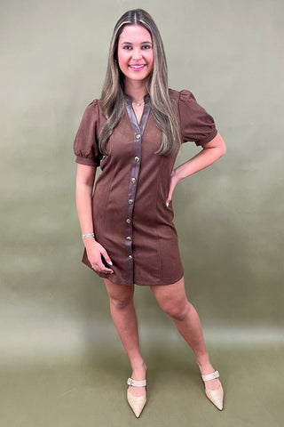 Woman wearing a brown dress with a green background