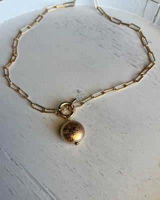 Shop the Gold Charm Necklace featuring a paperclip chain, textured gold charm, adjustable fit, and timeless style perfect for layering or everyday wear.