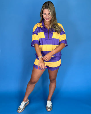 Woman wearing a purple and yellow striped outfit on a blue background