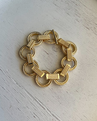 Shop the Gold Link Bracelet featuring oversized textured links, a polished gold finish, and a stylish toggle clasp for timeless everyday elegance.