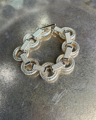 Shop the Gold Link Bracelet featuring oversized textured links, a polished gold finish, and a stylish toggle clasp for timeless everyday elegance.