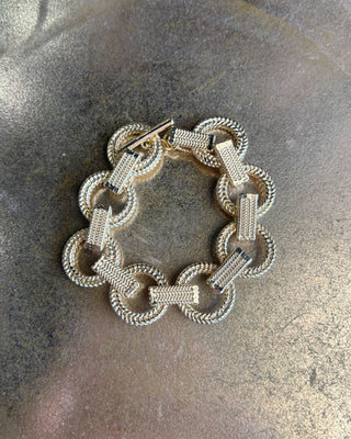 Shop the Gold Link Bracelet featuring oversized textured links, a polished gold finish, and a stylish toggle clasp for timeless everyday elegance.