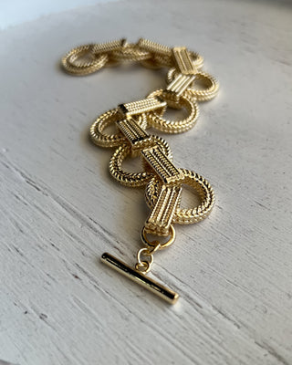 Shop the Gold Link Bracelet featuring oversized textured links, a polished gold finish, and a stylish toggle clasp for timeless everyday elegance.