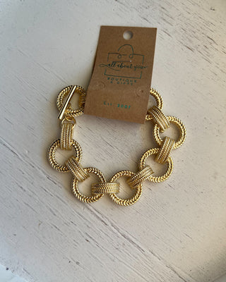 Shop the Gold Link Bracelet featuring oversized textured links, a polished gold finish, and a stylish toggle clasp for timeless everyday elegance.