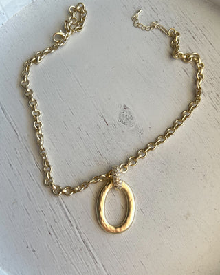 Shop the Matte Gold Chunky Necklace featuring a bold matte chain, organic oval pendant, crystal accent, and adjustable fit for effortless everyday style.