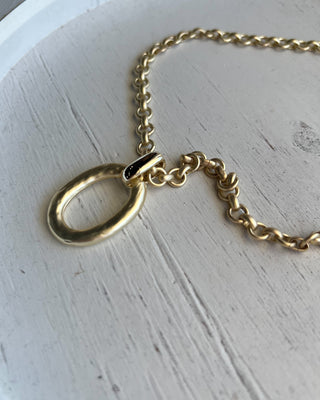 Shop the Matte Gold Chunky Necklace featuring a bold matte chain, organic oval pendant, crystal accent, and adjustable fit for effortless everyday style.