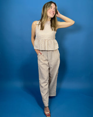 Tan and white gingham sleeveless peplum top with high neckline and matching wide leg pants set.