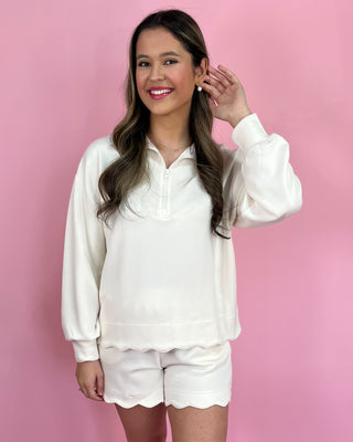 Woman wearing a white outfit against a pink background