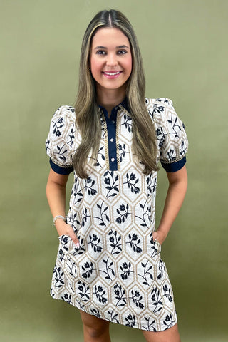 Woman wearing a patterned dress against a green background