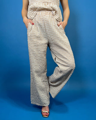 Tan and white gingham sleeveless peplum top with high neckline and matching wide leg pants set.