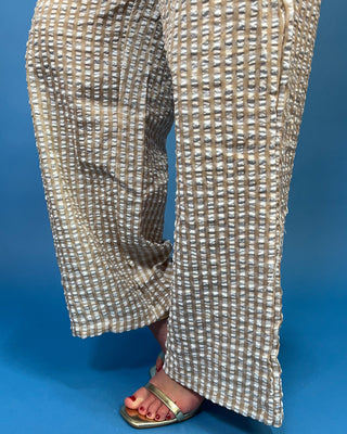 Tan and white gingham sleeveless peplum top with high neckline and matching wide leg pants set.
