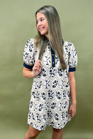 Woman wearing a patterned dress against a green background