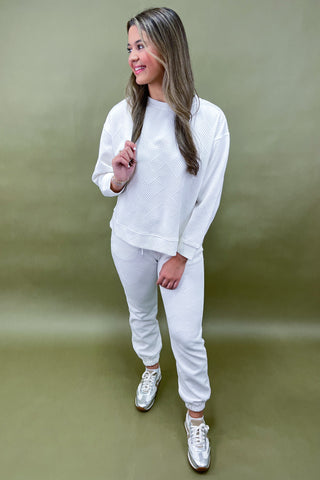 Woman wearing a white outfit on a green background