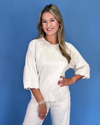 Woman wearing a white outfit against a blue background