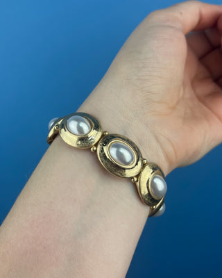Shop the Gold & Pearl Stretch Bracelet featuring antique gold accents, luminous faux pearls, and a comfortable stretch fit for timeless elegance.