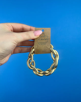 Shop the Chain-Link Bracelet featuring oversized matte gold links and a comfortable stretch design for effortless everyday style.
