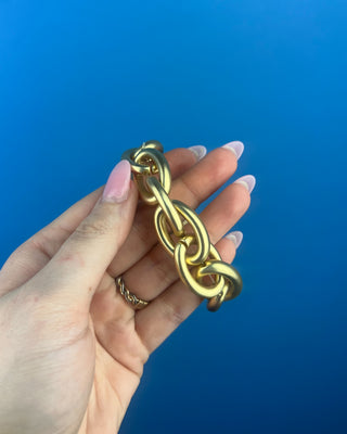 Shop the Chain-Link Bracelet featuring oversized matte gold links and a comfortable stretch design for effortless everyday style.