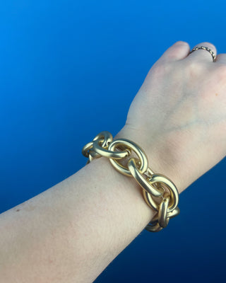 Shop the Chain-Link Bracelet featuring oversized matte gold links and a comfortable stretch design for effortless everyday style.